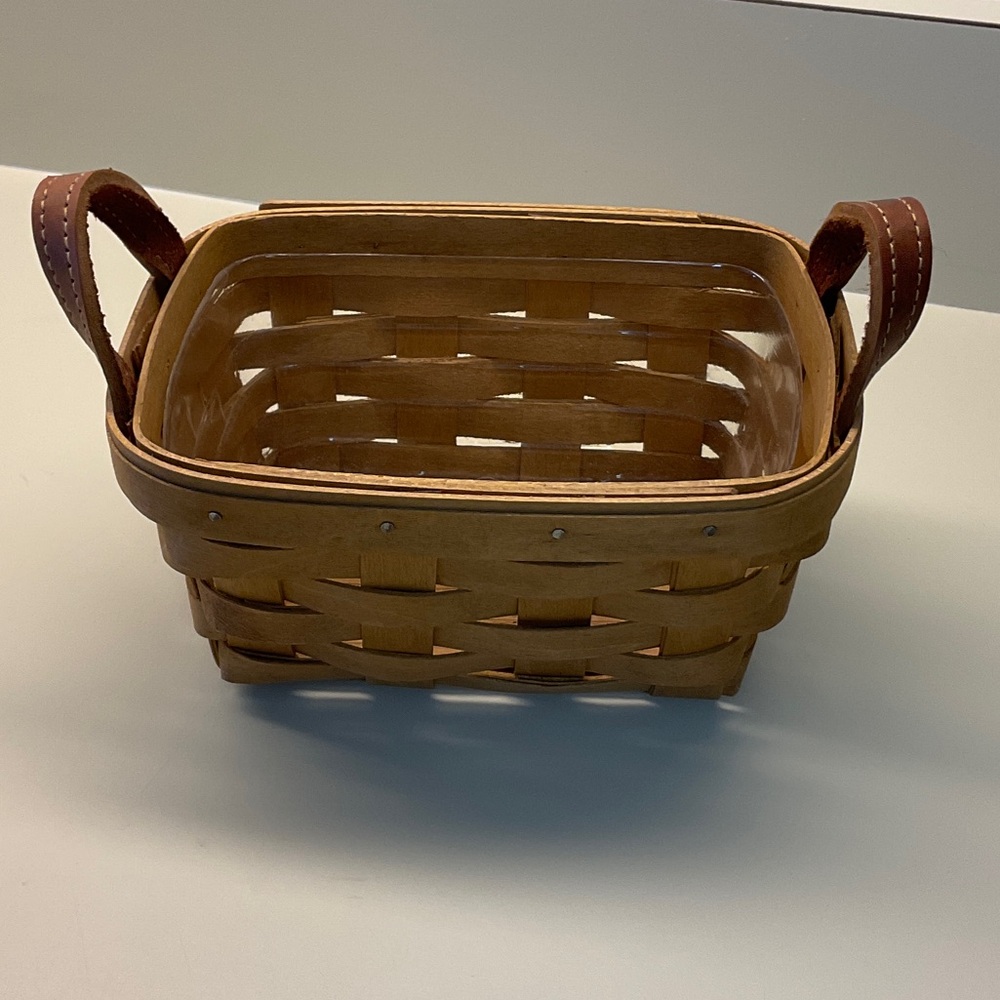 Longaberger Tea Basket with leather handles. Comes with protector.